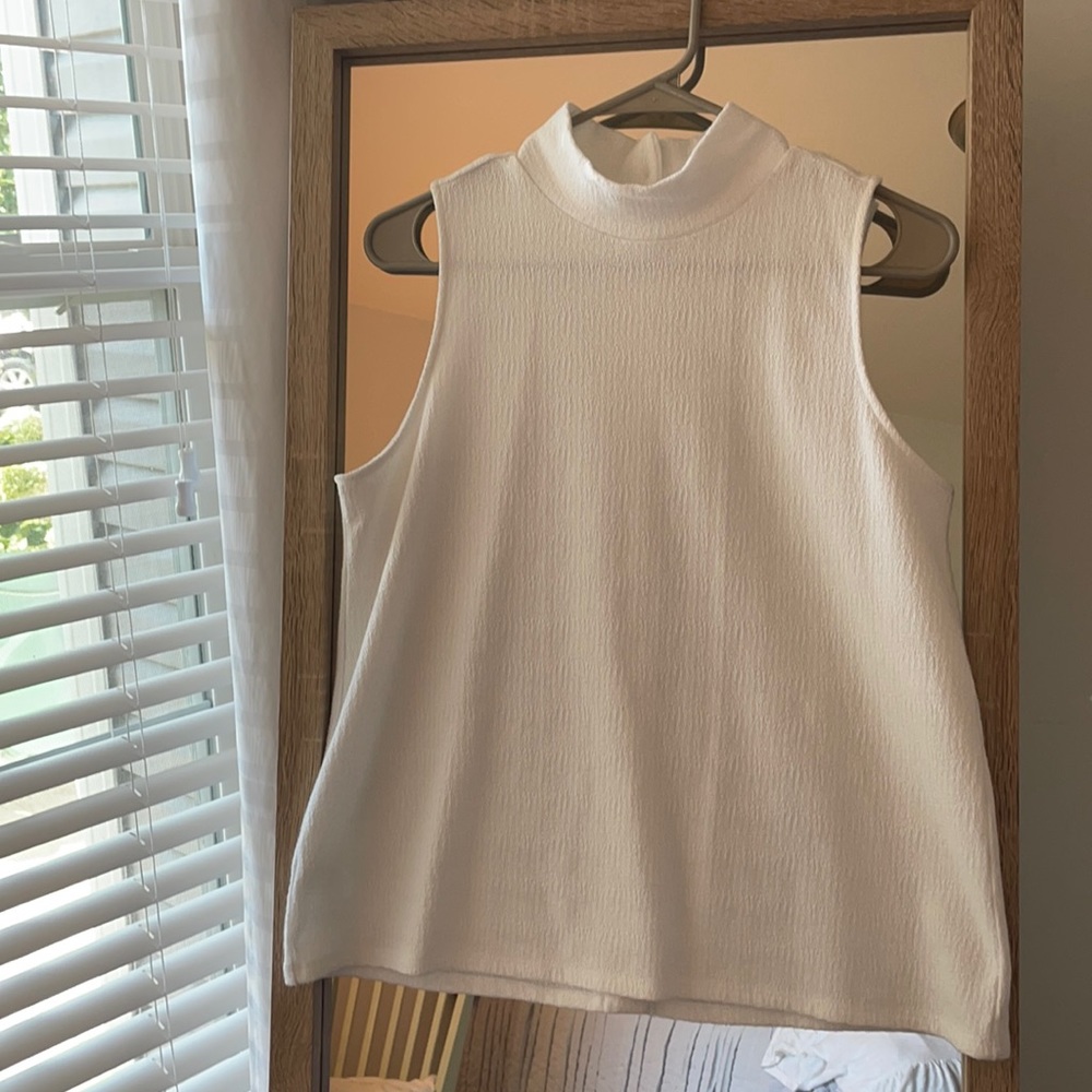 White sleeveless turtle neck with button-up back